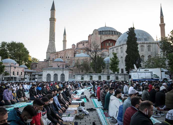 ISTANBUL, TURKEY - MAY 13: People take part in the Eid al-Fitr prayer amid a coronavirus lockdown outside the Hagia Sophia Grand Mosque on May 13, 2021 in Istanbul, Turkey. Eid al-Fitr is a three-day festival of feasting and celebration, marking the end of the muslim holy month of Ramadan. (Photo by Chris McGrath/Getty Images)
